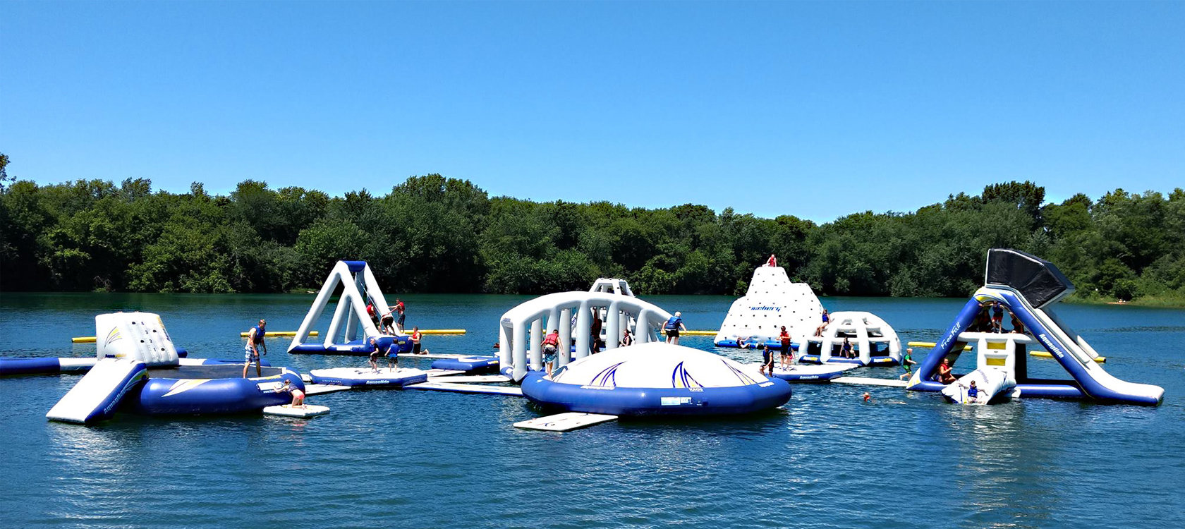 People playing on inflatable obstacles.