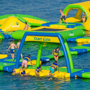 People playing on inflatable obstacle course.
