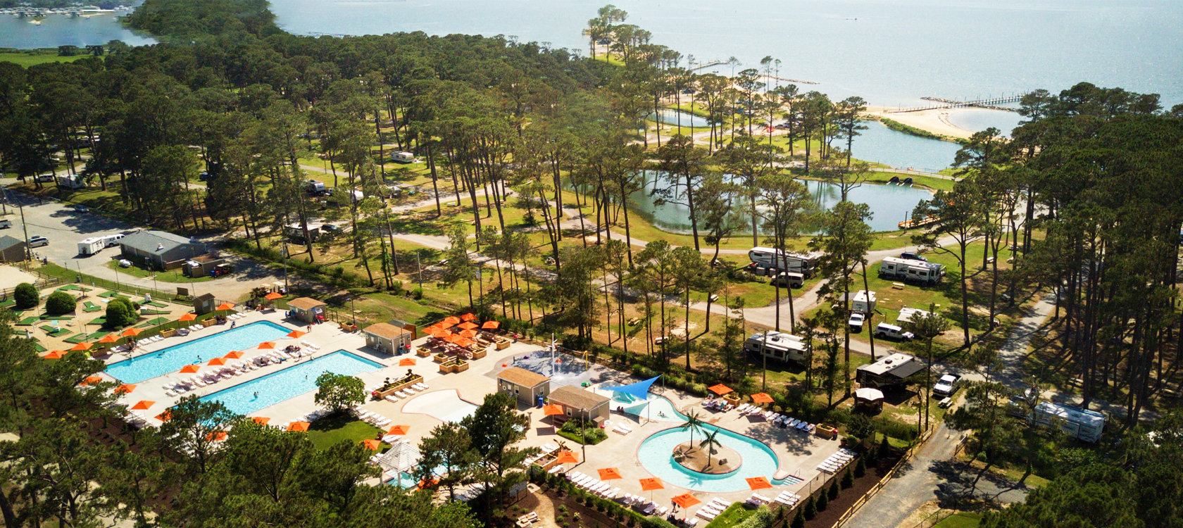 Birds eye view of lush resort right on the water.